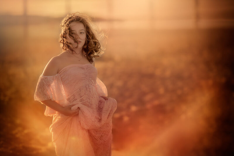 Canon-EOS-R-portret-van-een-jonge-vrouw-in-een-roze-jurk-op-het-strand-van-texel-tijdens-zonsondergang-en-de-magie-van-het-licht-door-apeldoornse-fotograaf-Willie-Kers