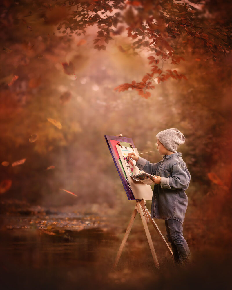 Canon-EOS-R5-painterly-portrait-of-a-little-boy-painting-an-autumn-landscape-in-the-fall-forest-by-dutch-natural-light-photographer-Willie-Kers-copy
